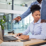 Screen-Shot-2024-02-09-at-6 Two colleagues looking at a laptop screen with a hand on shoulder